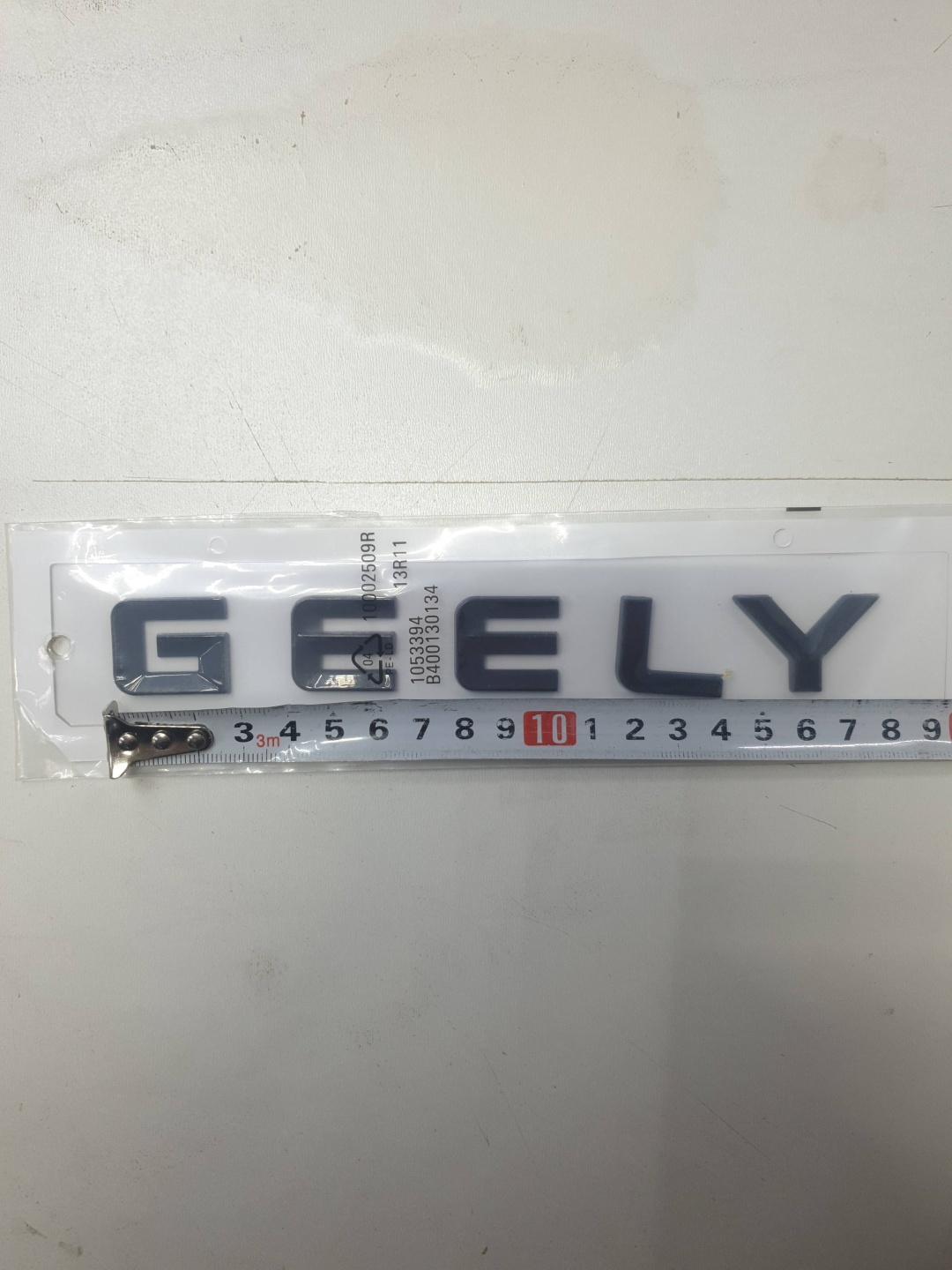 Шильдик 613841539 Geely Emgrand 7